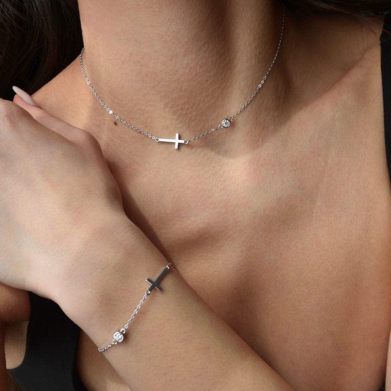 Сребърна гривна с мойсанит Holy, носена на ръка, с елегантен дизайн и кръстче.